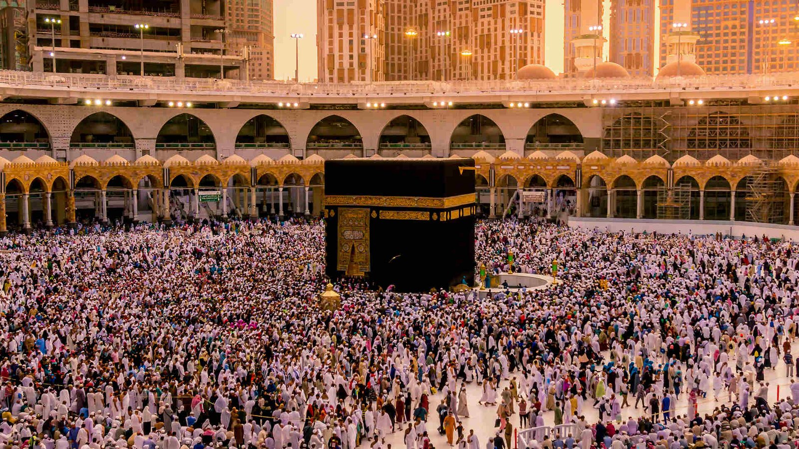 Illuminated Masjid al-Haram and Holy Kaaba surrounded by Umrah pilgrims
